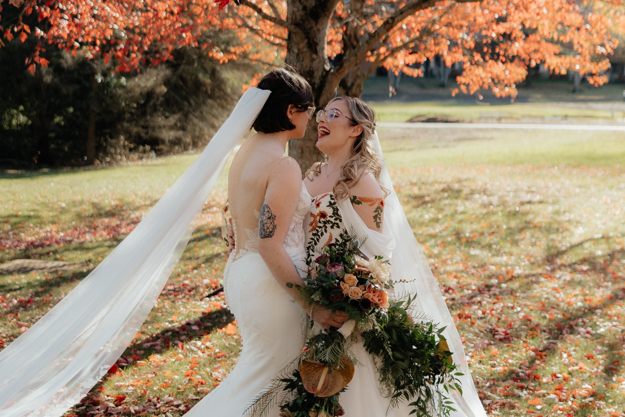 Two brides experience their first look during their autumn wedding at Holiday Valley in Ellicottville, New York