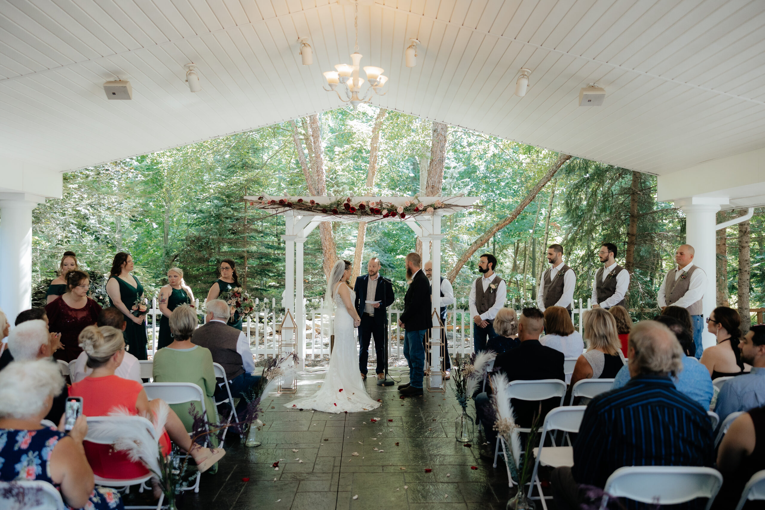 A ceremony takes place in the Garden Pavilion of Kloc's Grove wedding venue in Buffalo, New York.