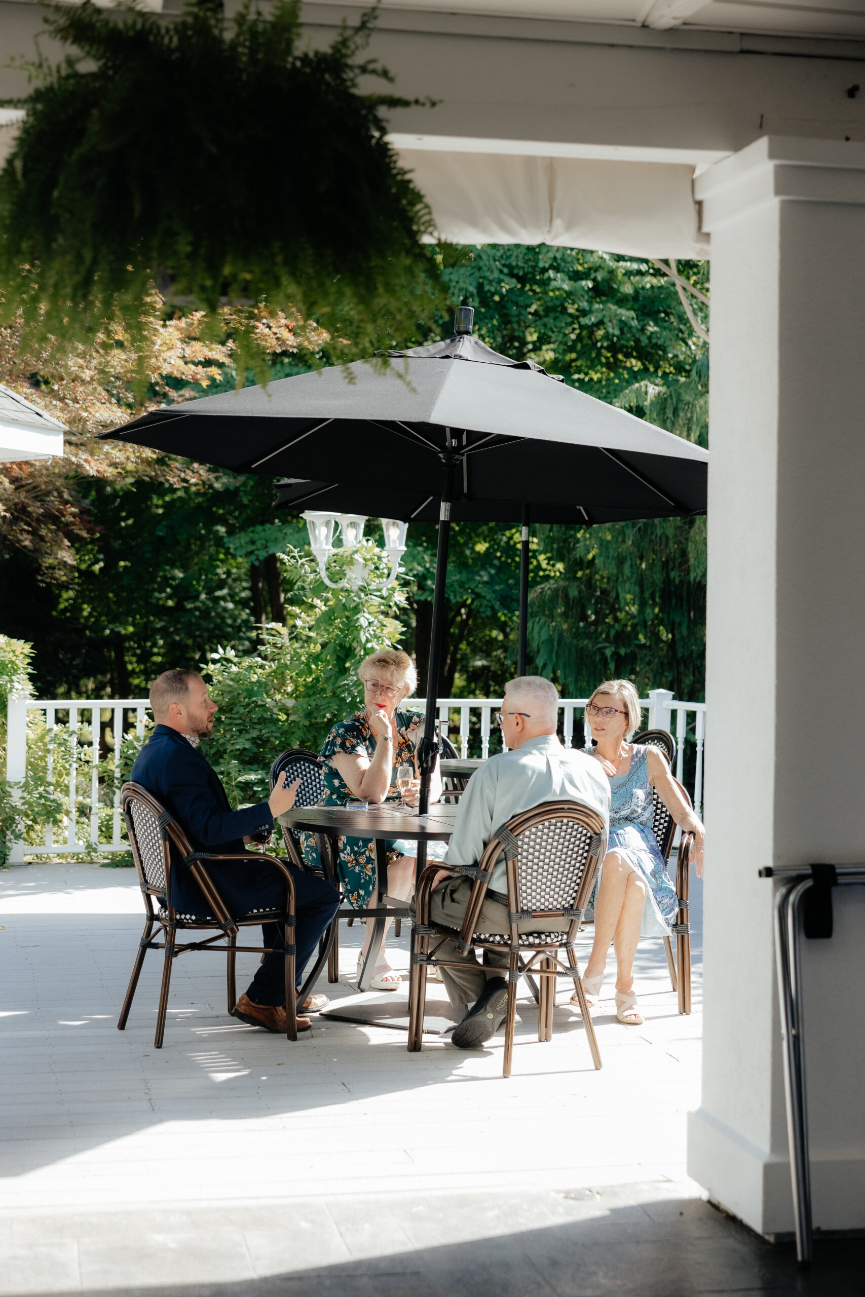Wedding guests enjoying an outdoor cocktail hour at the Garden Pavilion of Kloc's Grove wedding venue in West Seneca, New York.